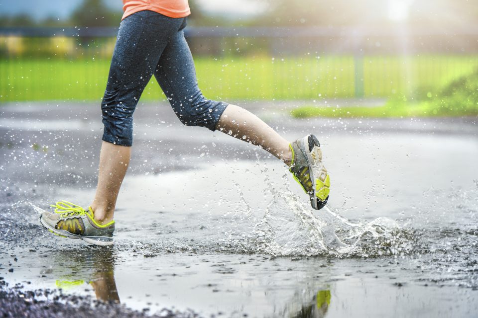 Person running under the rain